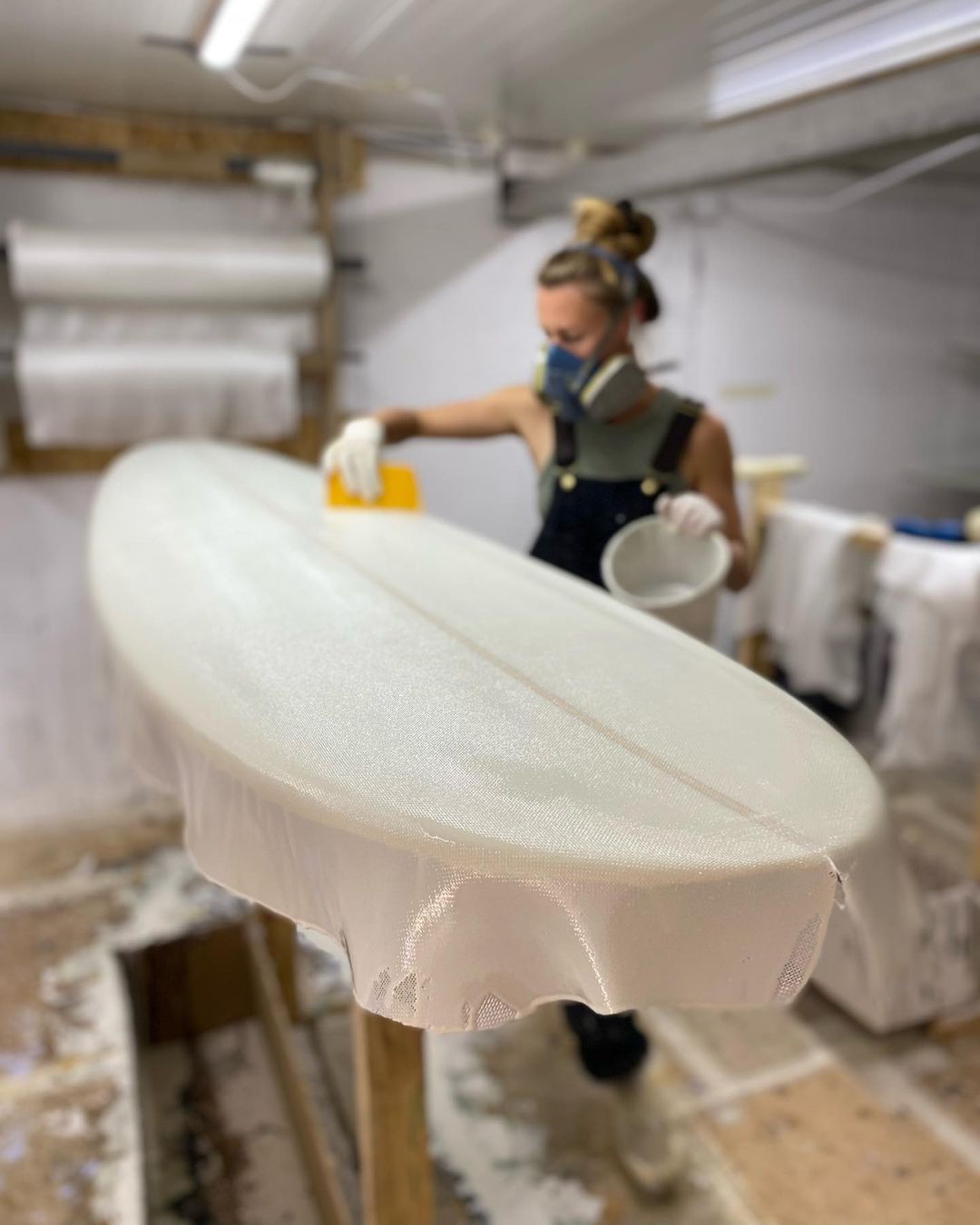 A local surfboard shaper building a surfboard